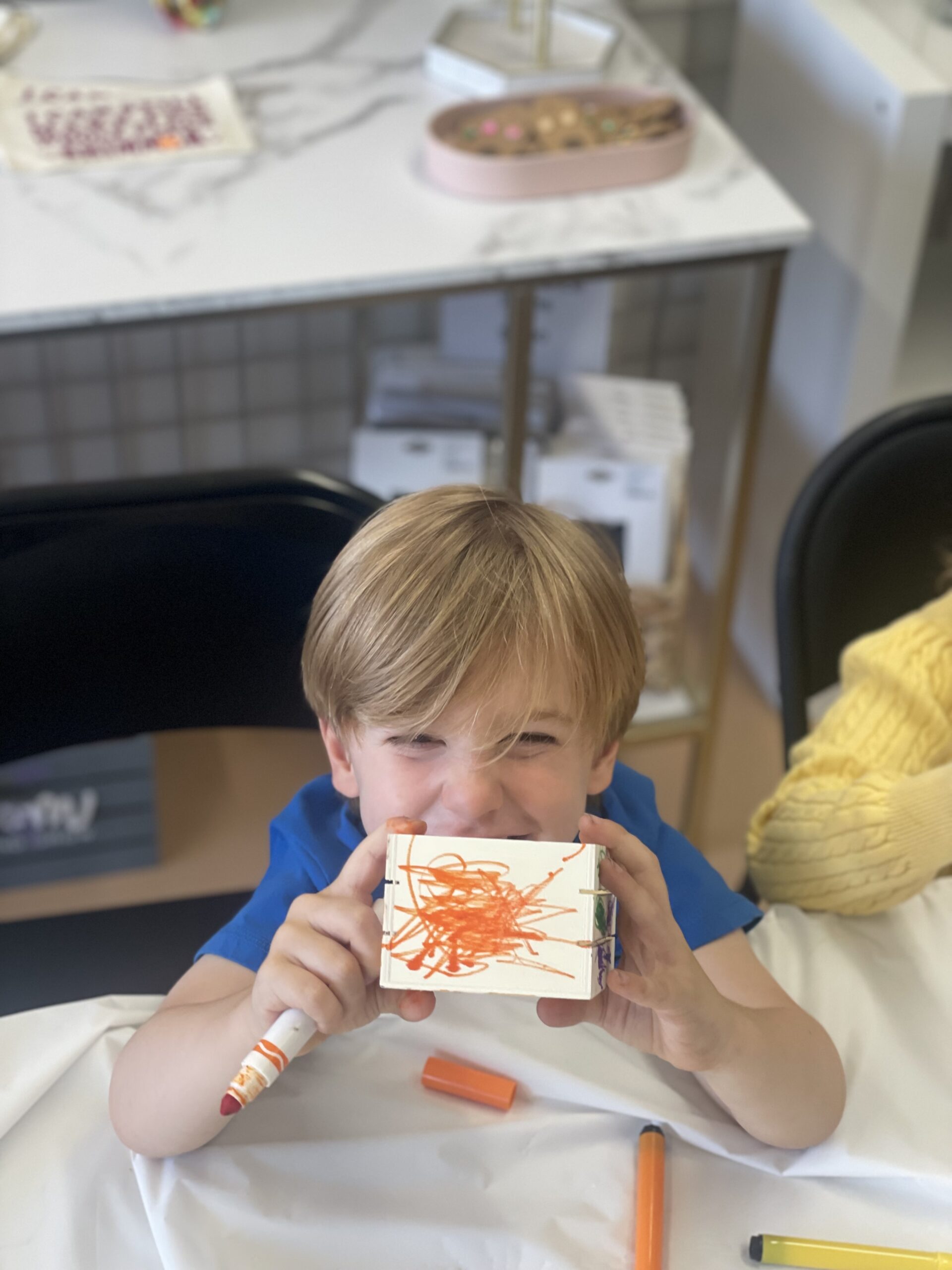 Boy showing off his art project at summer camp in Johnson City NY